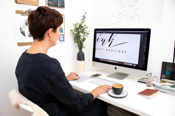 woman designing a logo on the computer